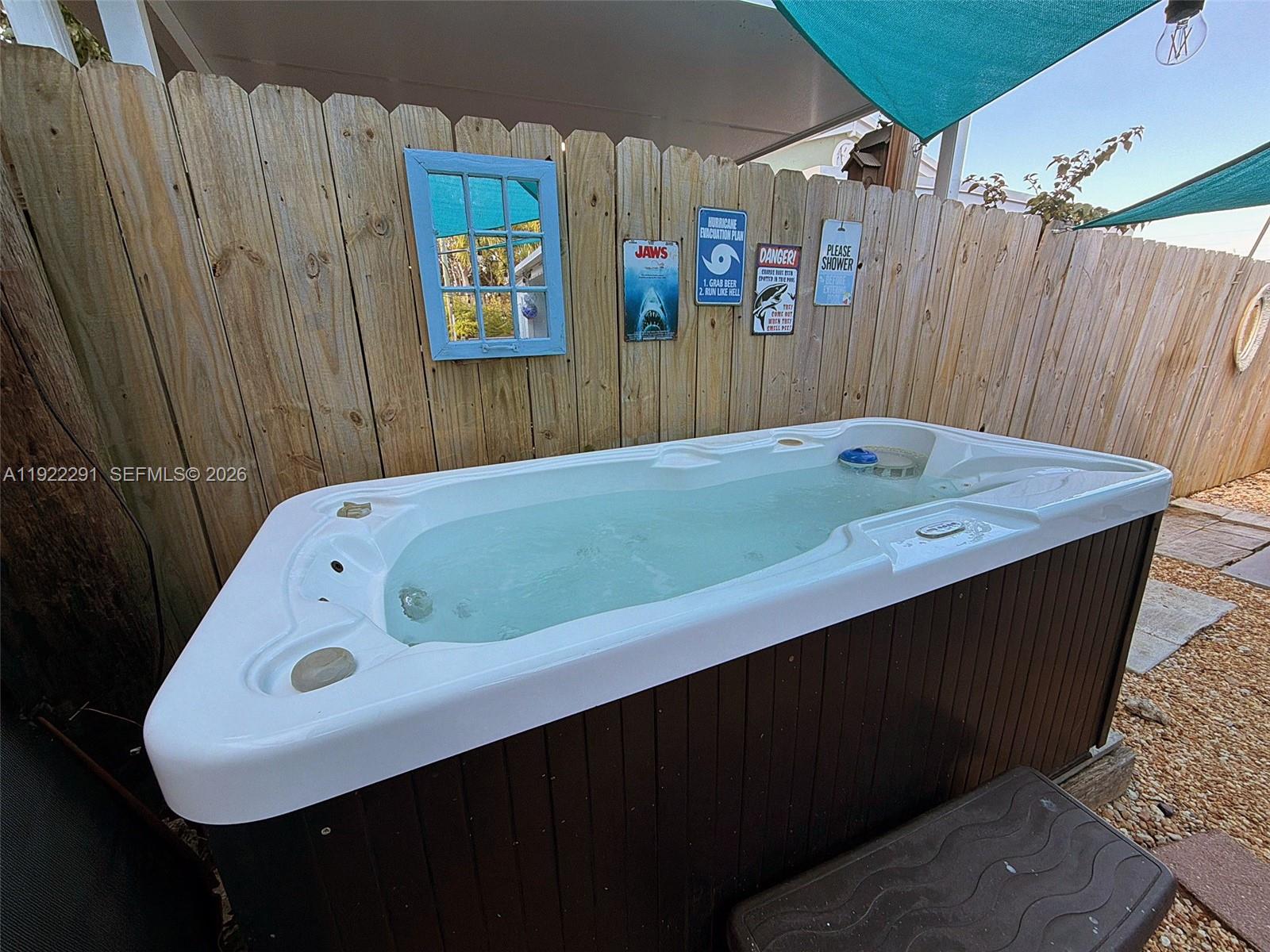 40 Pirates Drive Key Largo, FL 33037 - Photo 7 of 38 a bathroom with a tub sink and a mirror