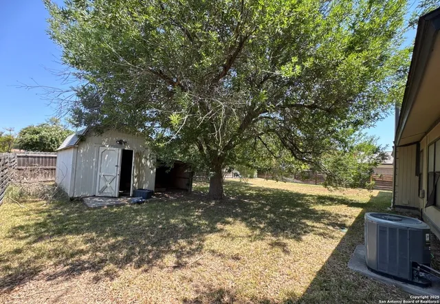 a view of a backyard with large trees and a small yard