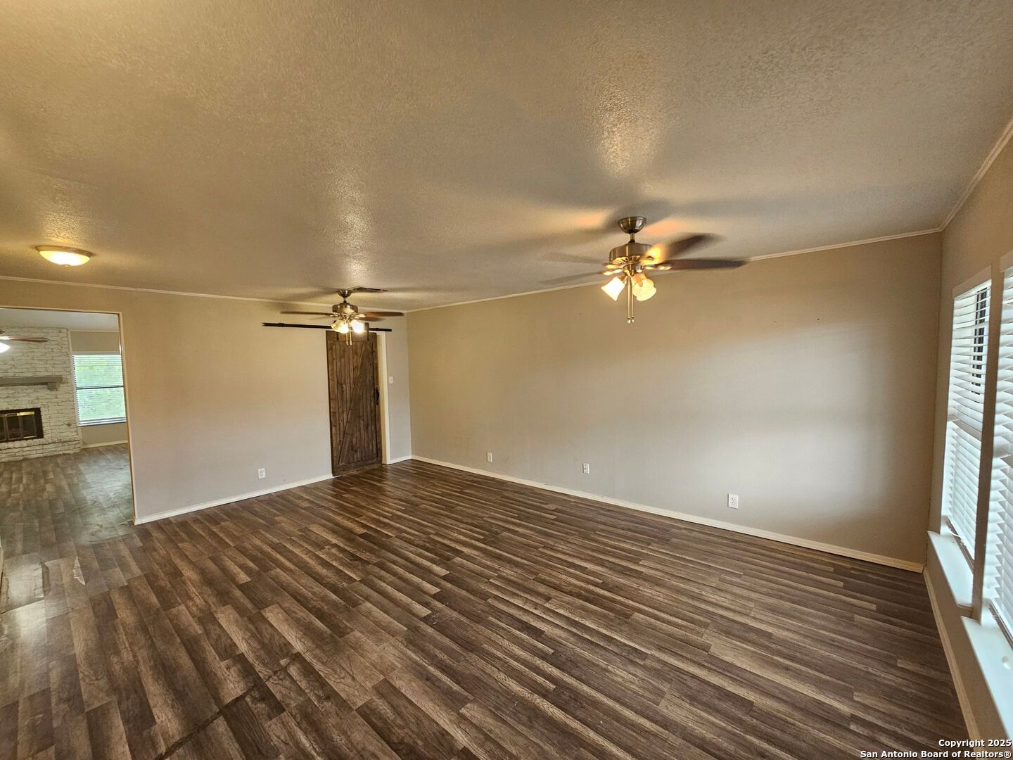 5303 Walnut Vista Drive San Antonio, TX 78247 - Photo 2 of 18 a view of a livingroom with a ceiling fan and wooden floor
