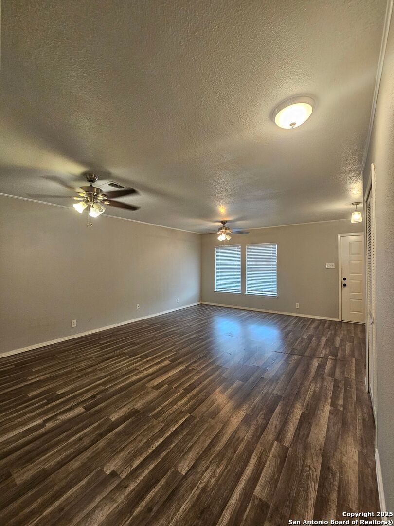 5303 Walnut Vista Drive San Antonio, TX 78247 - Photo 3 of 18 a view of empty room with wooden floor and fan