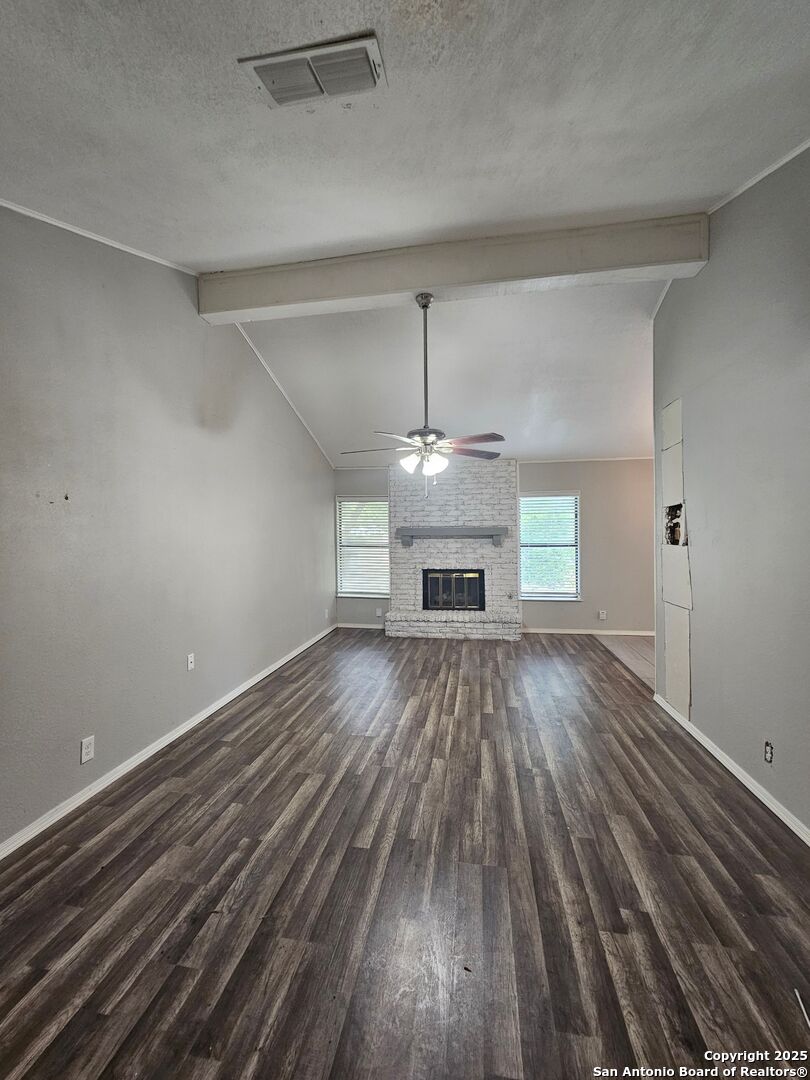 5303 Walnut Vista Drive San Antonio, TX 78247 - Photo 4 of 18 a view of empty room with a fireplace and wooden floor