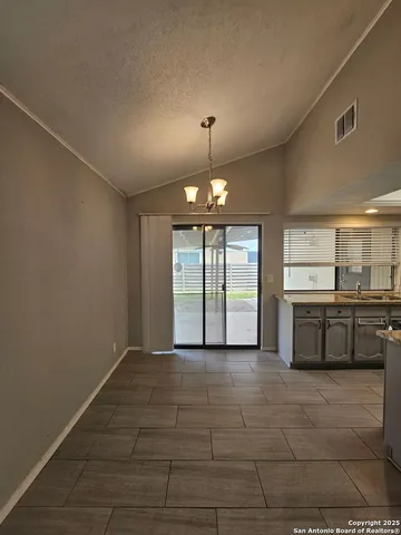 a view of a kitchen with a sink and a window