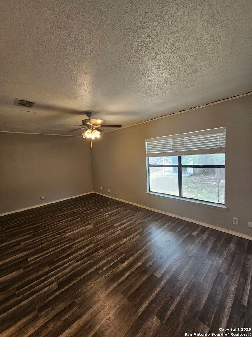 5303 Walnut Vista Drive San Antonio, TX 78247 - Photo 8 of 18 a view of empty room with wooden floor and fan
