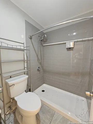 a bathroom with a toilet and a bath tub