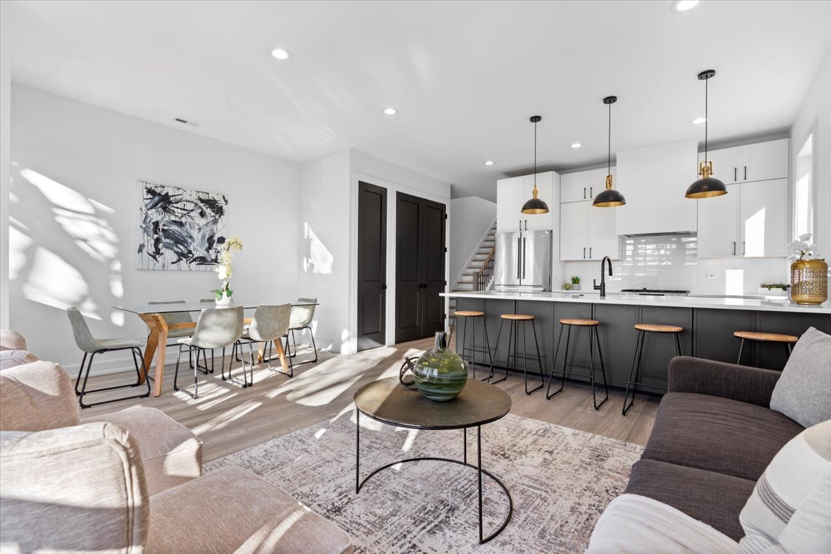 2636 West Evergreen Avenue, Unit 3 Chicago, IL 60622 - Photo 2 of 22 a living room with kitchen furniture kitchen view and a chandelier