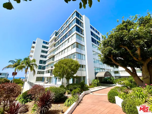 a view of a building with a yard