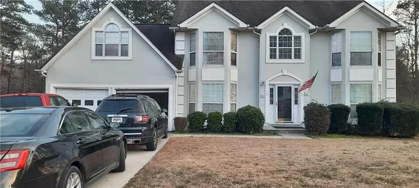 a front view of a house with a yard