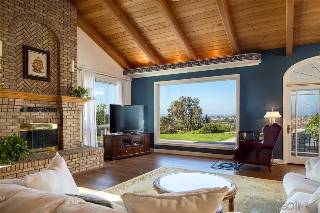 12966 Lomas Verdes Drive Poway, CA 92064 - Photo 13 of 25 a living room with fireplace furniture and a flat screen tv