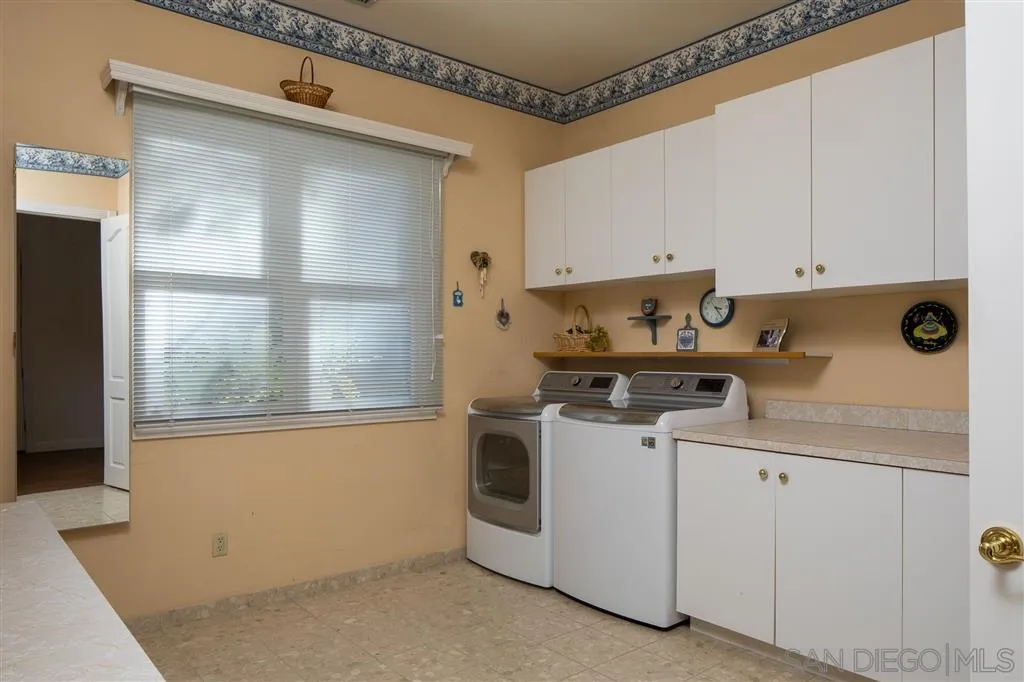 12966 Lomas Verdes Drive Poway, CA 92064 - Photo 18 of 25 a kitchen with white cabinets and white appliances
