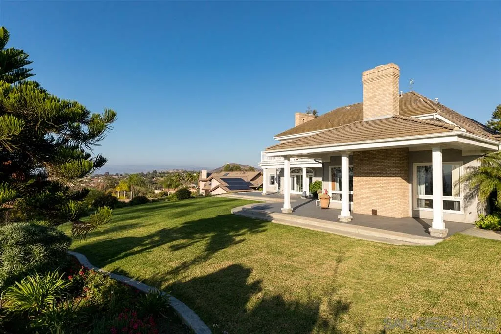 12966 Lomas Verdes Drive Poway, CA 92064 - Photo 24 of 25 a front view of a house with a yard table and chairs