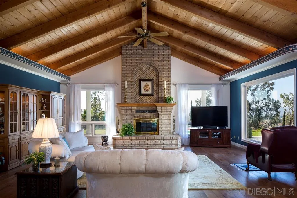 12966 Lomas Verdes Drive Poway, CA 92064 - Photo 10 of 25 a living room with furniture a fireplace and a large window