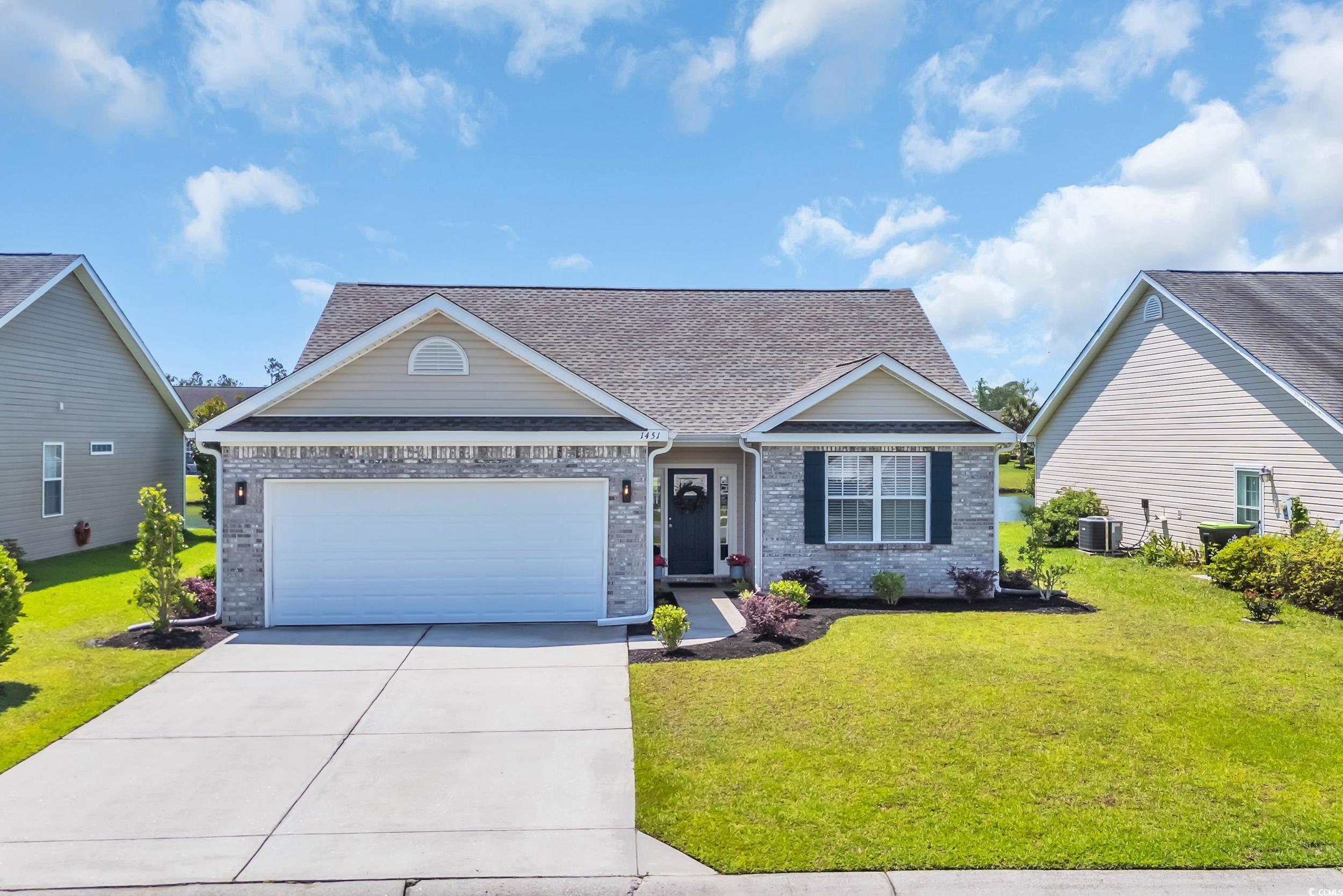 View of front of home featuring concrete driveway,