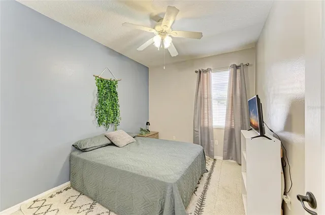 a view of a swimming pool with a patio and a backyard