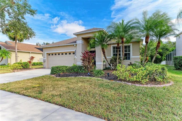 a front view of a house with a tree