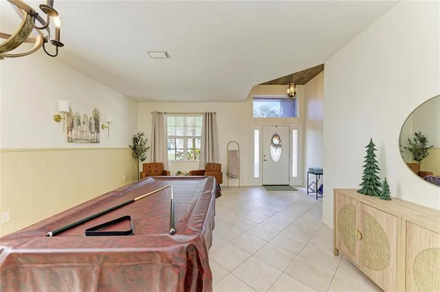 a living room with furniture and a kitchen