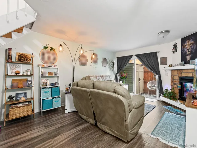 a living room with furniture and a book shelf