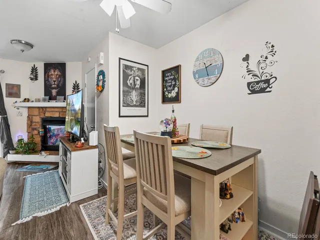 a view of a dining room with furniture wooden floor and a clock