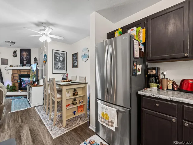 a kitchen with stainless steel appliances granite countertop a refrigerator and a stove top oven