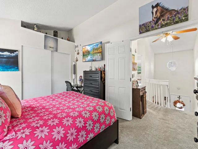 a bedroom with a bed and a refrigerator