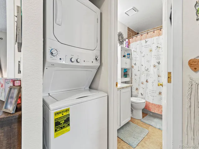 a view of bathroom with a toilet and a shower curtain