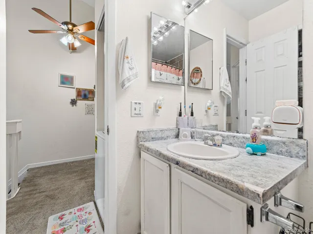 a bathroom with a granite countertop sink a vanity and a mirror
