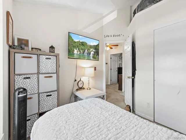a bedroom with a bed and a flat screen tv
