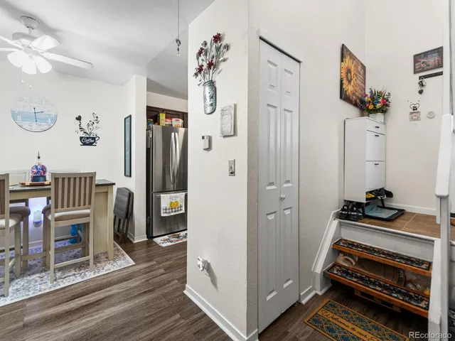 a view of hall way with furniture and wooden floor
