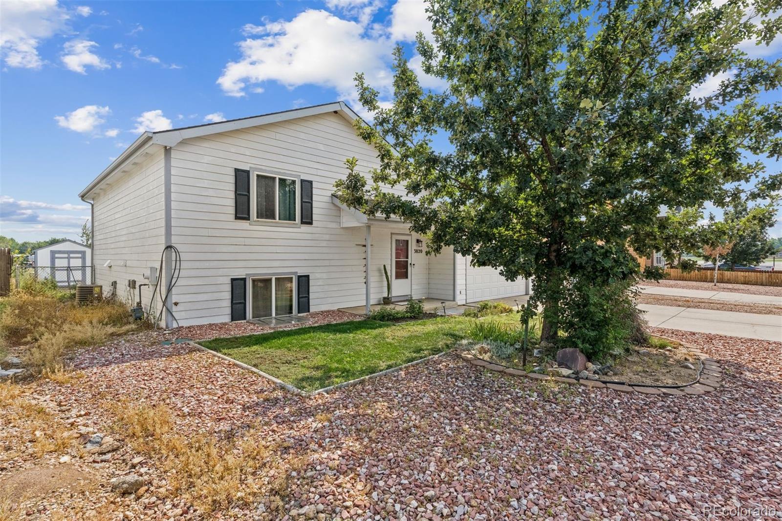 3820 Riverside Parkway Evans, CO 80620 - Photo 20 of 25 a view of a house with a yard