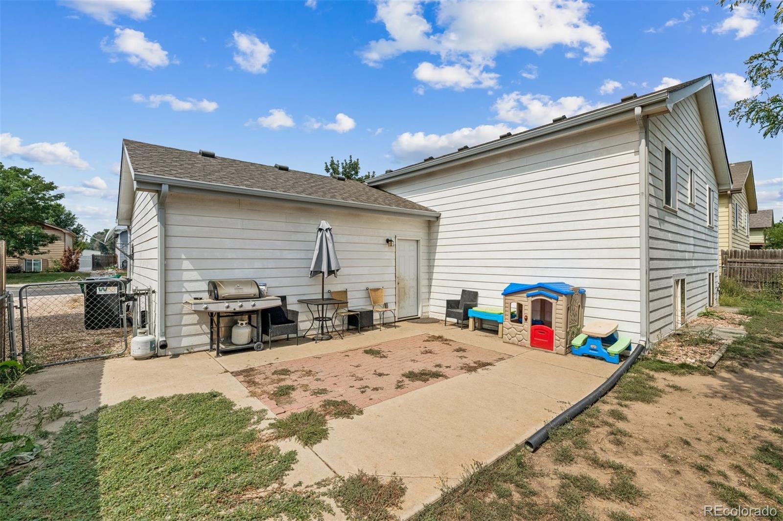 3820 Riverside Parkway Evans, CO 80620 - Photo 23 of 25 a view of a house with table and chairs in patio