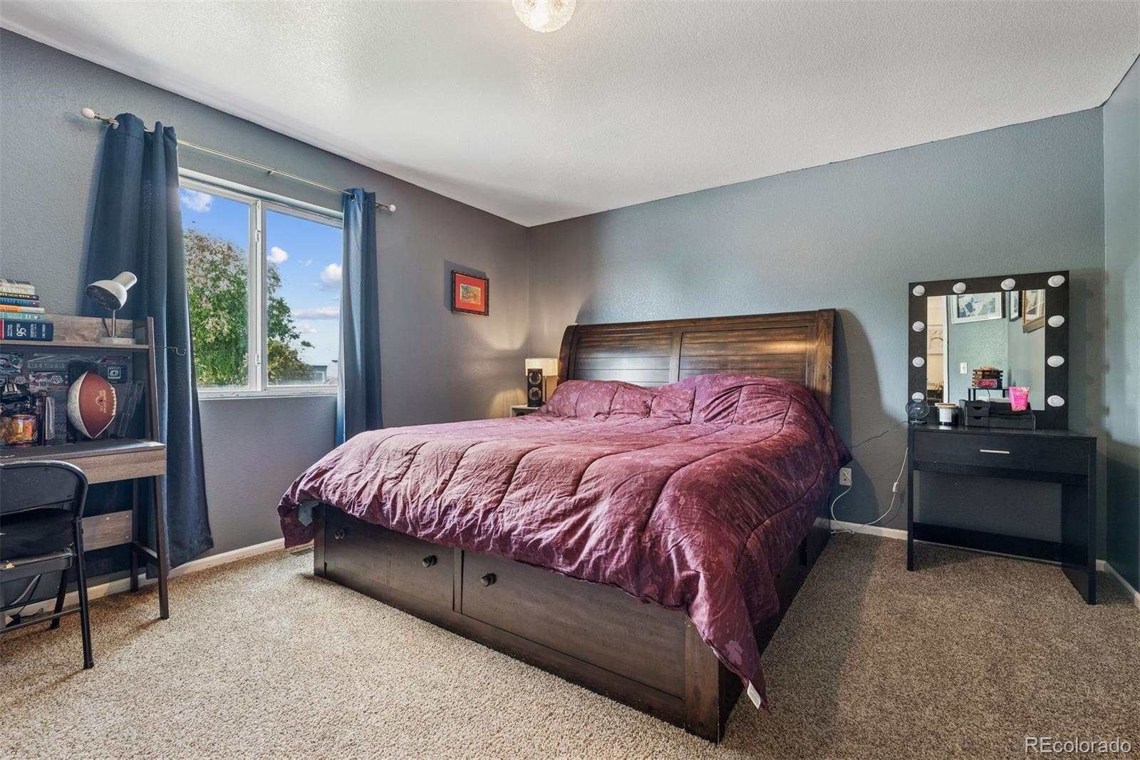3820 Riverside Parkway Evans, CO 80620 - Photo 4 of 25 a bed sitting in a bedroom next to a window
