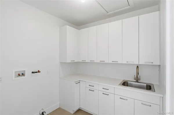 a view of white cabinets and sink