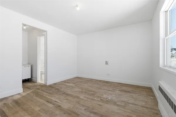 an empty room with windows and closet