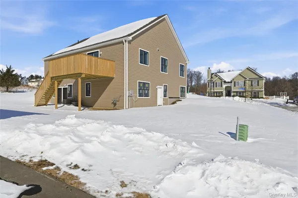 a view of a house with a snow in the background