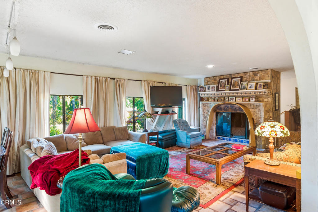 1400 Park Road Ojai, CA 93023 - Photo 22 of 67 a living room with furniture a fireplace and a floor to ceiling window