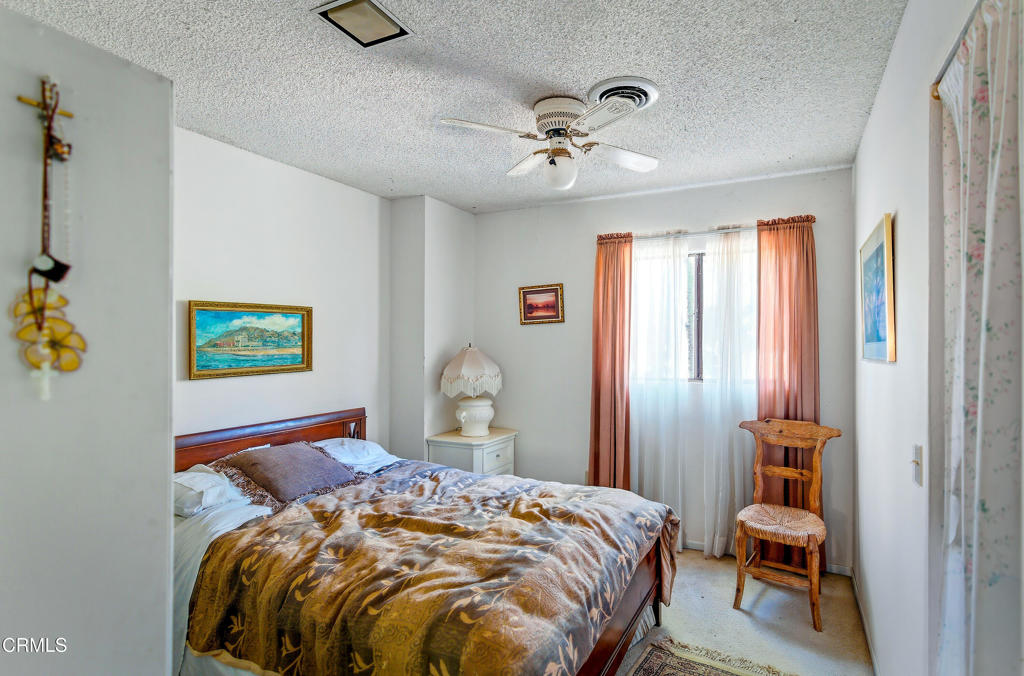 1400 Park Road Ojai, CA 93023 - Photo 26 of 67 a bedroom with a bed and a chandelier