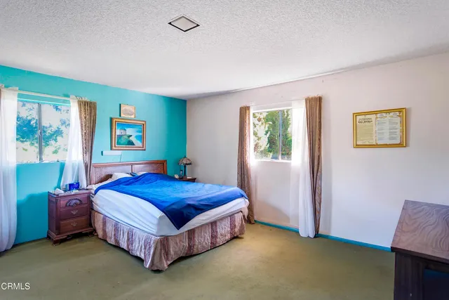 a bedroom with two beds and a couch