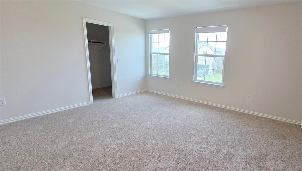 916 Elizabeth Street Anna, TX 75409 - Photo 11 of 31 an empty room with windows and closet