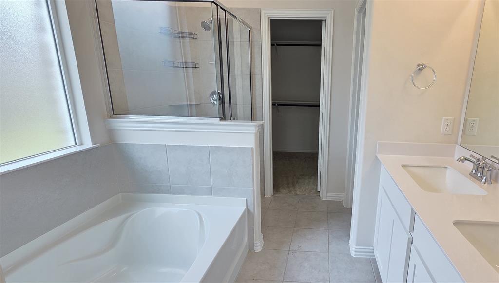 916 Elizabeth Street Anna, TX 75409 - Photo 20 of 31 a bathroom with a tub sink and mirror