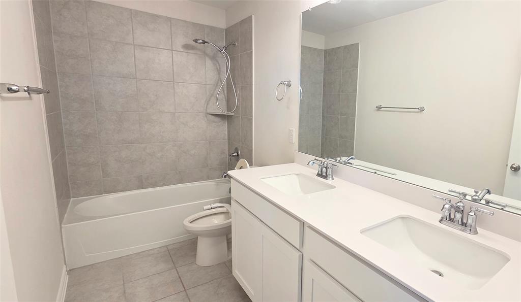 916 Elizabeth Street Anna, TX 75409 - Photo 23 of 31 a bathroom with a sink a toilet and shower