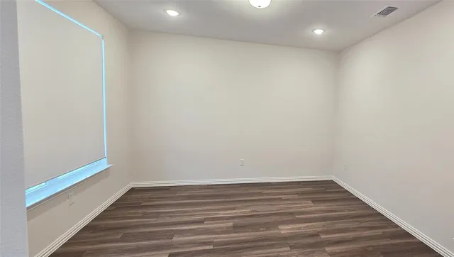 a view of room with wooden floor