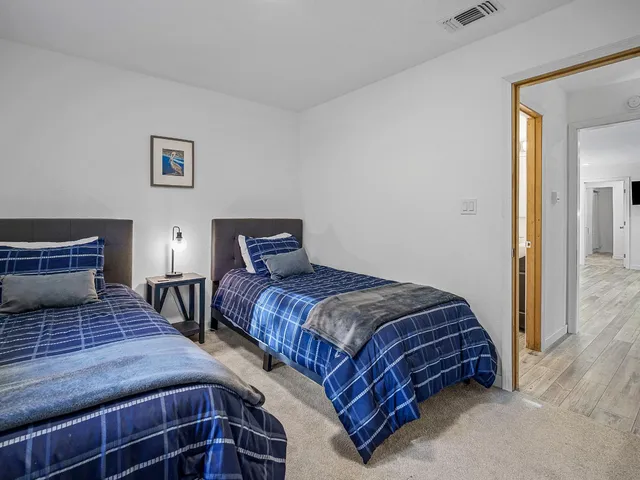 a bedroom with a bed and two night stand