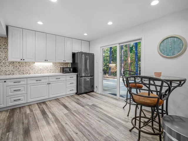 a kitchen with stainless steel appliances wooden floors and wooden cabinets