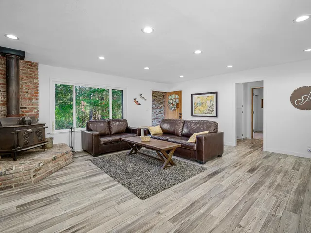 a living room with furniture window and a wooden floor