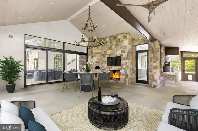 a living room with furniture a chandelier and a large window