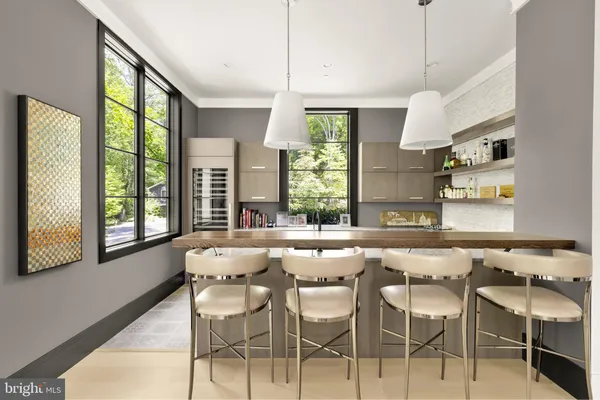 a kitchen with granite countertop a stove a table and chairs in it