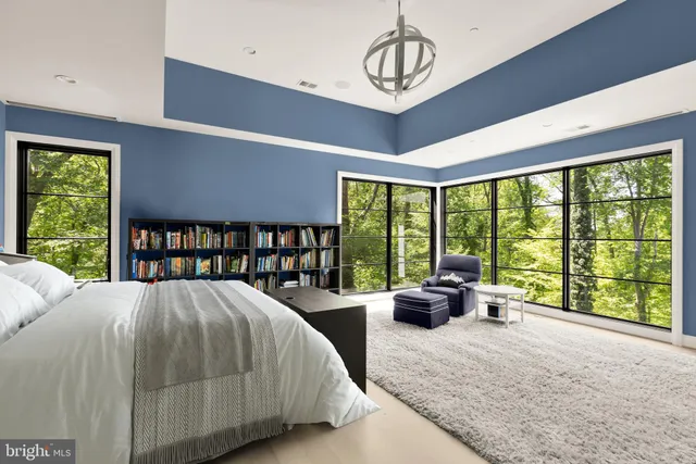 a bed room with a bed and a large window