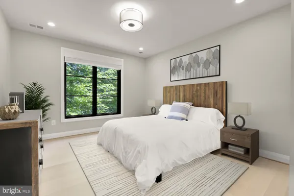 a bedroom with a large bed and a window