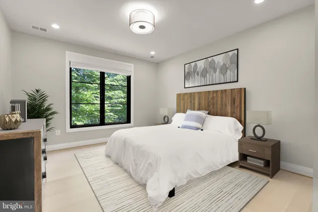 a bedroom with a large bed and a window