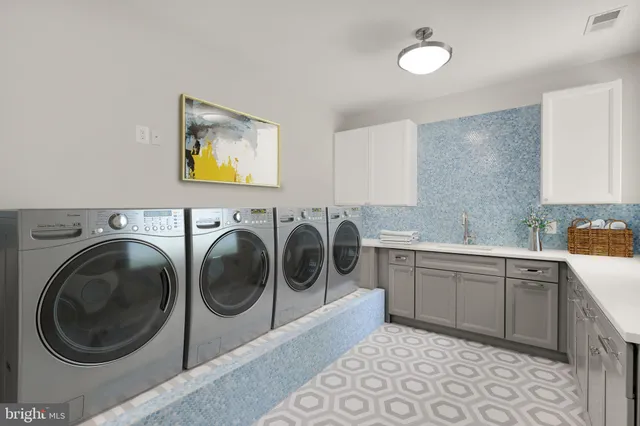 a utility room with sink dryer and washer