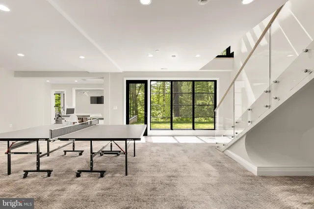 a view of an entryway with a table and chairs